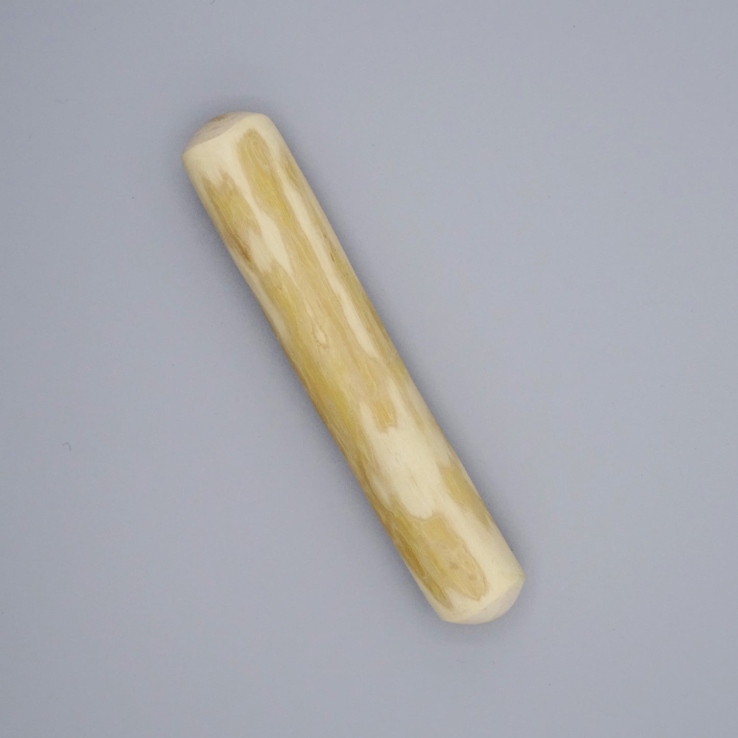 Small coffee wood sticks with natural grain on a gray background